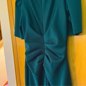 Green, elegant gown. Flattering to the figure. Tucks right where you need them.